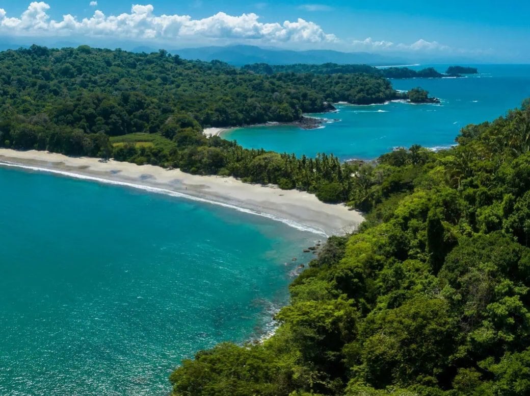 Aerial view of a turquoise beach and rainforest at Manuel Antonio National Park, Costa Rica